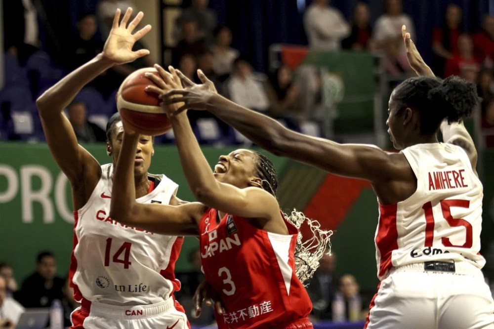 Canada's women's basketball team will need some help to qualify for the Paris Olympics. Kayla Alexander, left, and Laeticia Amihere, right, of Canada in action against Mawuli Stephanie of Japan during the women' basketball Olympic qualifying tournament third round match between Canada and Japan in Sopron, Hungary, Sunday, Feb. 11, 2024. THE CANADIAN PRESS/AP-MTI, Zsombor Toth