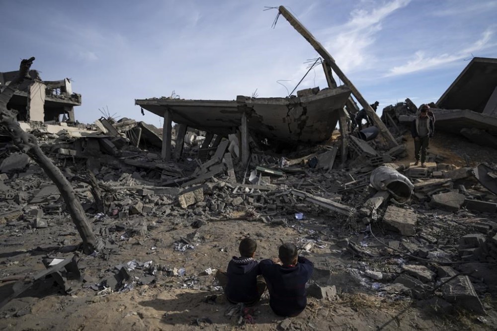 Palestinians inspect the damage to residential buildings where two Israeli hostages were reportedly held before being rescued during an operation by Israeli security forces in Rafah, southern Gaza Strip, Monday, Feb. 12, 2024. The Israeli military said early Monday that it had rescued the two hostages from captivity in the Gaza Strip. The operation, which was accompanied by airstrikes, killed dozens of Palestinians, according to local health officials. (AP Photo/Fatima Shbair)