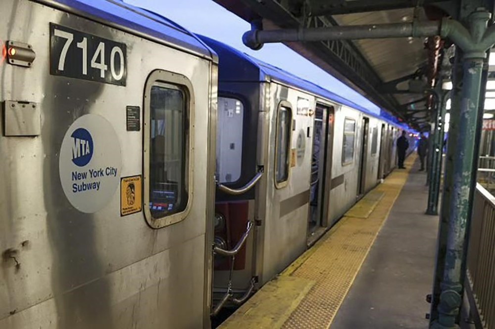 New York Police walk through the Mount Eden subway station while investigating a shooting on the platform, Monday, Feb. 12, 2024, in the Bronx borough of New York. Several people were shot Monday at the New York City subway station, police said. (New York Police Department via AP)