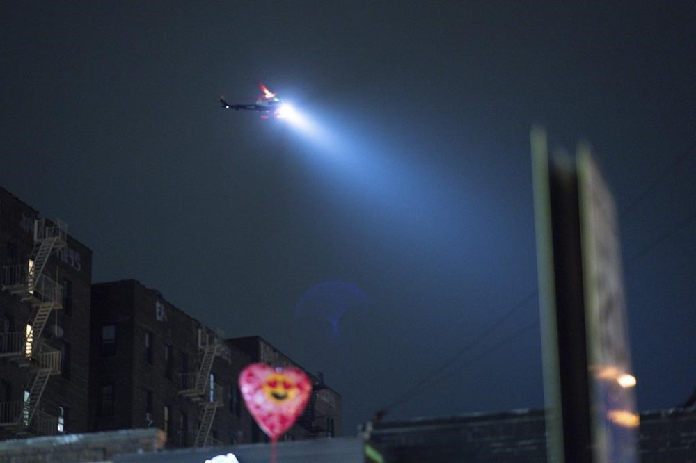 A NYPD helicopter patrols around the area after a shooting at the Mt. Eden Ave. Subway station, Monday, Feb. 12, 2024, in the Bronx borough of New York. (AP Photo/Eduardo Munoz Alvarez)