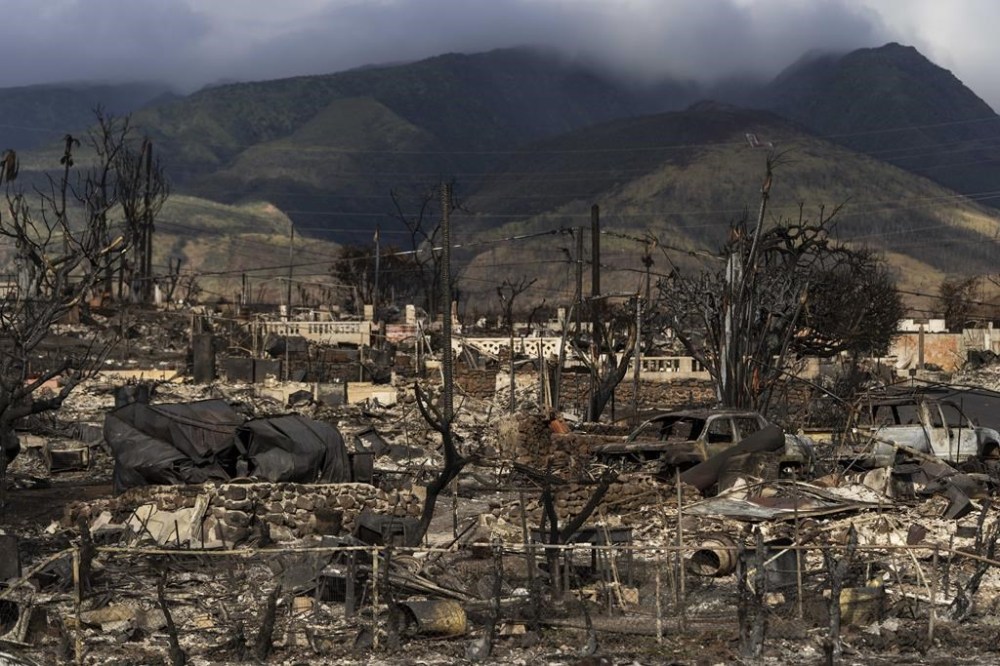 FILE - Damaged property lies scattered in the aftermath of a wildfire in Lahaina, Hawaii, Aug. 21, 2023. The death toll from the Lahaina wildfire rose to 101 on Tuesday, Feb. 13, 2024, after Maui police confirmed the identity of one new victim, a 76-year-old man. Paul Kasprzycki of Lahaina died in the fire, Maui police said. (AP Photo/Jae C. Hong, File)