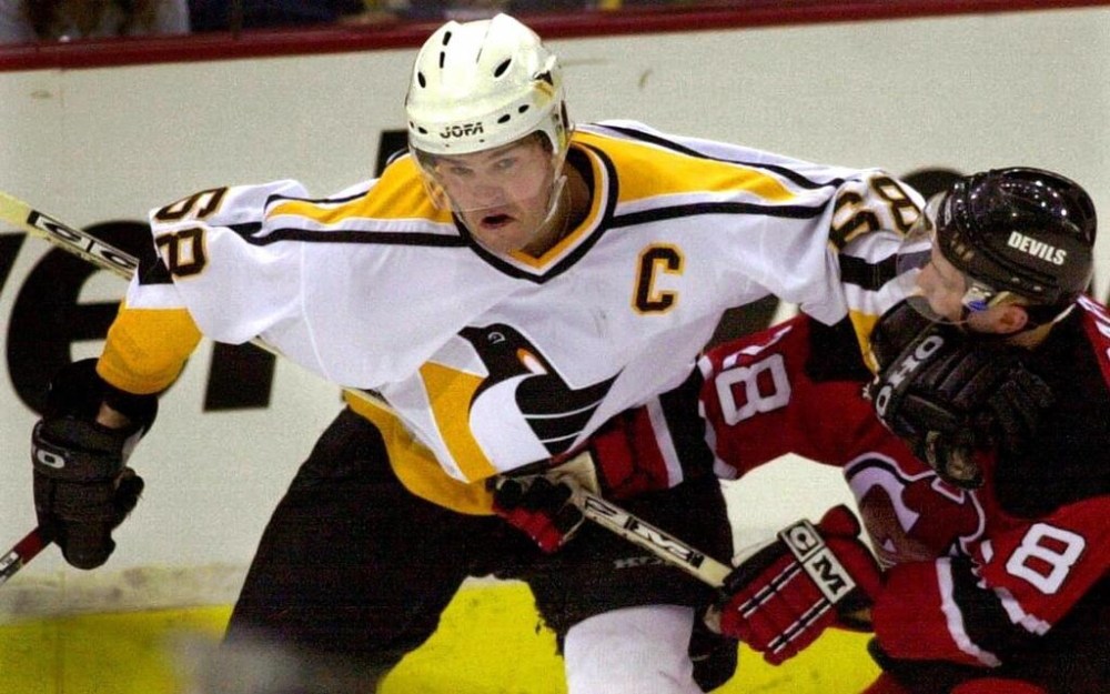 Pittsburgh Penguins' Jaromir Jagr (68) battles New Jersey Devils defenceman Brian Rafalski (28) during second period NHL playoff action Thursday May 17, 2001, in Pittsburgh. THE CANADIAN PRESS/AP-Gene J. Puskar