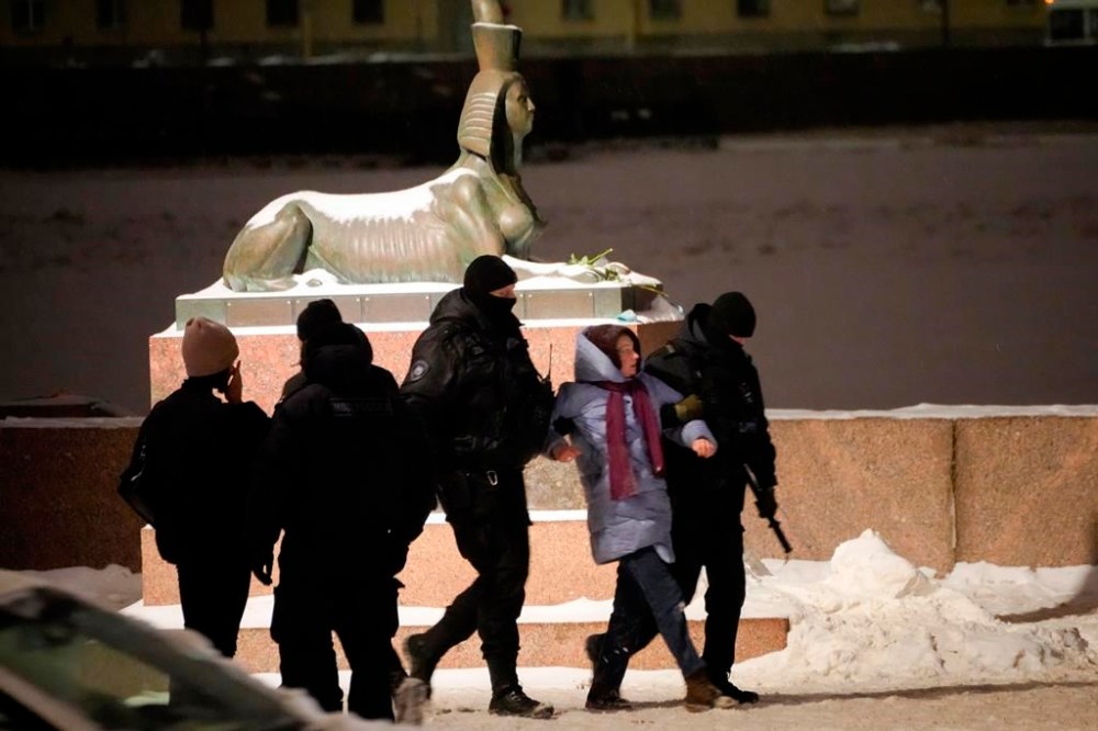 Police officers detain a woman who laid flowers to pay her last respect to Alexei Navalny at the Memorial to Victims of Political Repression in St. Petersburg, Russia on Friday, Feb. 16, 2024. Russian authorities say that Alexei Navalny, the fiercest foe of Russian President Vladimir Putin who crusaded against official corruption and staged massive anti-Kremlin protests, died in prison. He was 47. (AP Photo)