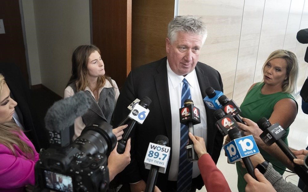 Defense attorney Mark Collins speaks to the media while co-counsel Kaitlyn Stephens stand behind him after a mistrial is declared in the trial of Michael Jason Meade at the Franklin County Common Pleas Court on Friday, Feb. 16, 2024 in Columbus, Ohio. Meade was charged with murder and reckless homicide in the December 2020 killing of Casey Goodson Jr. (Brooke LaValley/The Columbus Dispatch via AP)