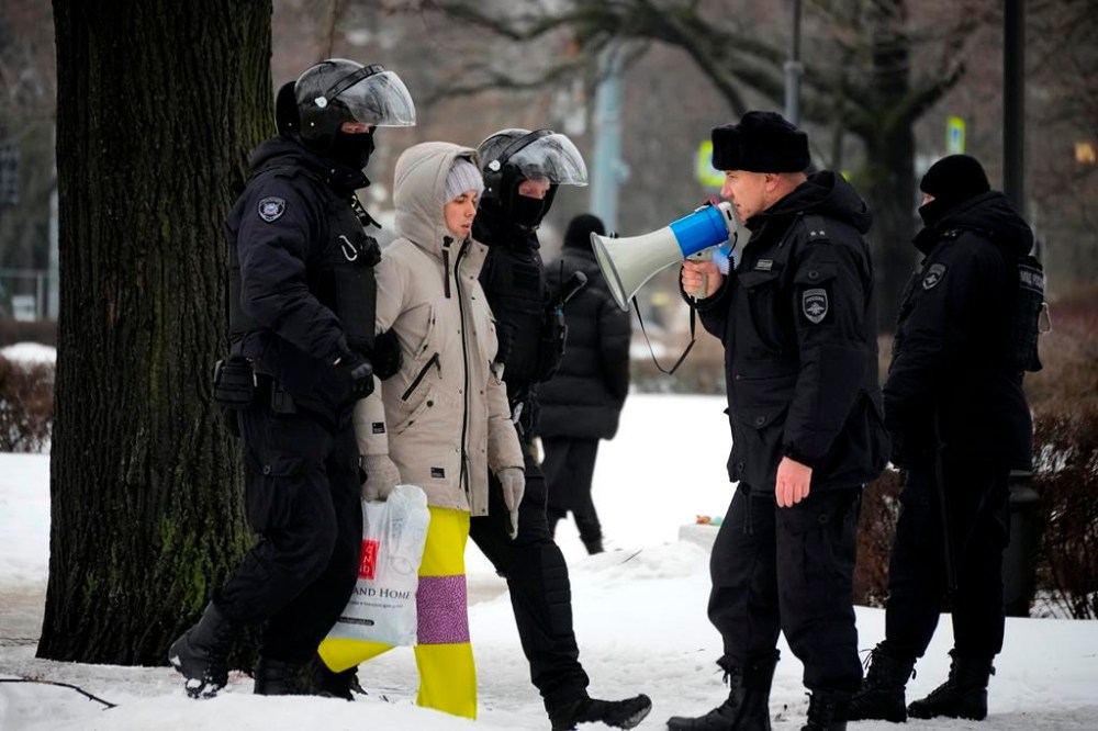 Police detain a man as he wanted to lay flowers paying their last respect to Alexei Navalny at the monument, a large boulder from the Solovetsky islands, where the first camp of the Gulag political prison system was established, in St. Petersburg, Russia on Saturday, Feb. 17, 2024. Russian authorities say that Alexei Navalny, the fiercest foe of Russian President Vladimir Putin who crusaded against official corruption and staged massive anti-Kremlin protests, died in prison. He was 47. (AP Photo)