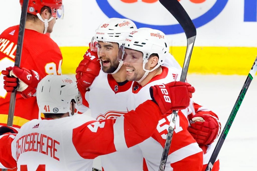Detroit Red Wings LW David Perron, rt, Detroit Red Wings left wing David Perron (57) celebrates his goal against the Calgary Flames with teammates during second period NHL hockey action in Calgary on Saturday, Feb. 17, 2024. THE CANADIAN PRESS/Larry MacDougal