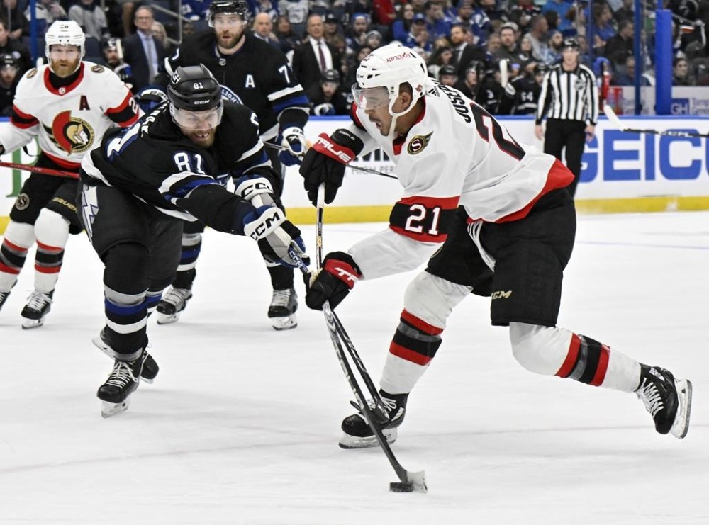 Ottawa Senators right wing Mathieu Joseph (21) scores as Tampa Bay Lightning defenseman Erik Cernak (81) defends during the first period of an NHL hockey game Monday, Feb. 19, 2024, in Tampa, Fla. (AP Photo/Jason Behnken)