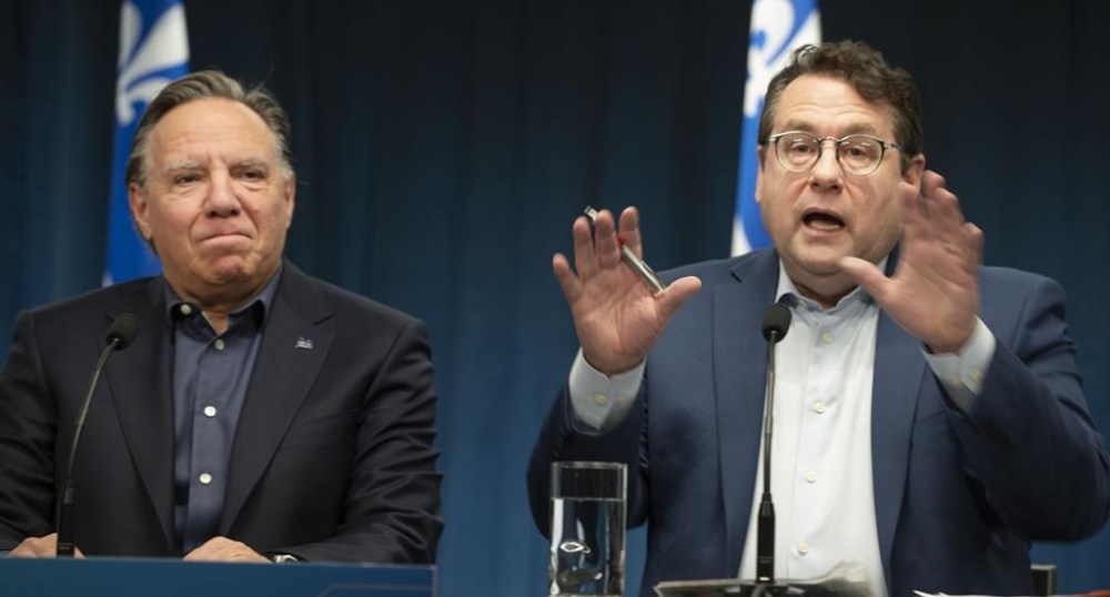 The Quebec government is once again going public with its demands that Ottawa do more to ease the pressure of asylum seekers in the province. Bernard Drainville, Quebec Minister of Education. speaks to the press alongside Quebec Premiere Francois Legault during a press conference in Montreal, Sunday, Feb. 18, 2024. THE CANADIAN PRESS/Peter McCabe