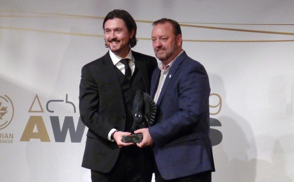 Cavalry FC’s Tommy Wheeldon Jr. receives his coach of the year award from commissioner David Clanachan, in Toronto, Tuesday, Nov. 26, 2019. Wheeldon Jr. cast his mind back to a 1985 Hollywood movie when asked about his CPL team's preparations for Wednesday's CONCACAF Champions first-leg match against Major League Soccer's Orlando City SC. THE CANADIAN PRESS/Neil Davidson