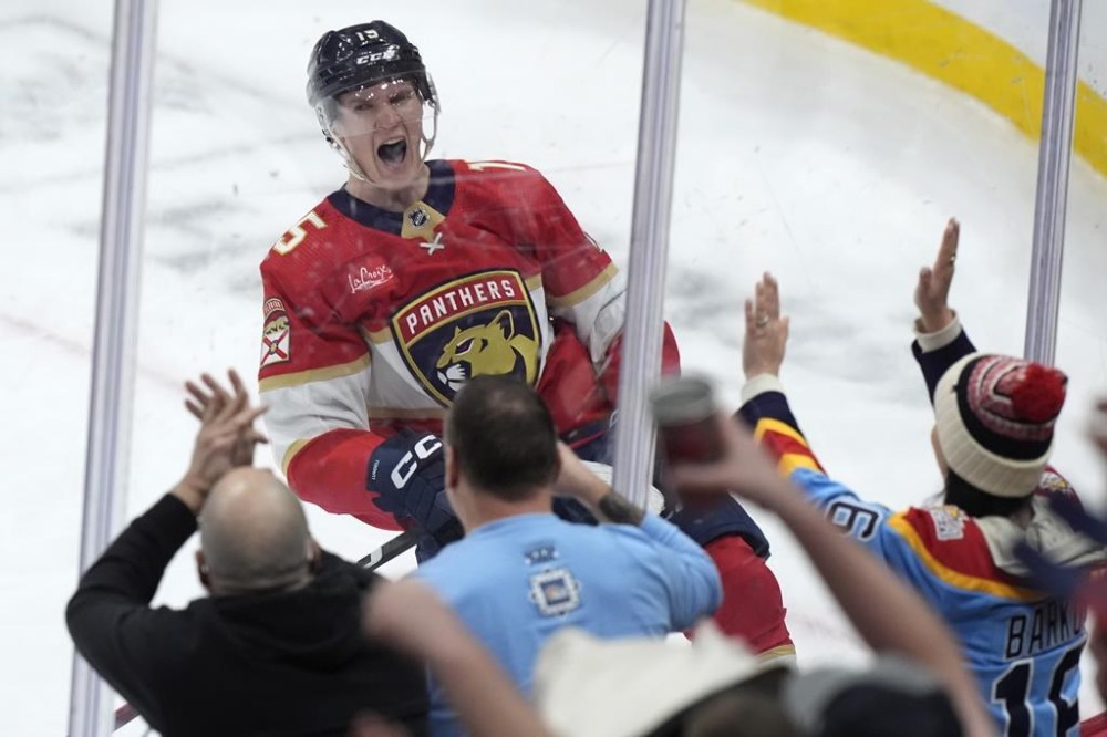 Florida Panthers center Anton Lundell celebrates after he scored the winning goal during an overtime period of an NHL hockey game against the Ottawa Senators, Tuesday, Feb. 20, 2024, in Sunrise, Fla. The Panthers beat the Senators 3-2 in overtime. (AP Photo/Wilfredo Lee)