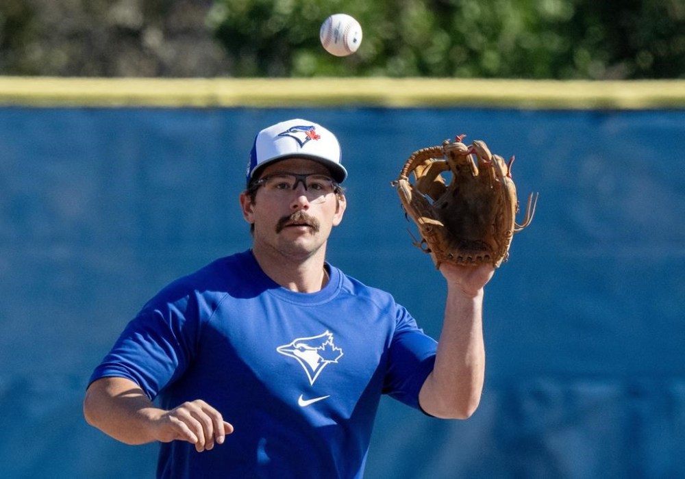 Toronto Blue Jays Davis Schneider fields a ball in Spring Training action in Dunedin, Fla. on Wednesday, February 21, 2024. Schneider is getting his first taste of big-league training camp even though he's no longer a rookie. THE CANADIAN PRESS/Frank Gunn