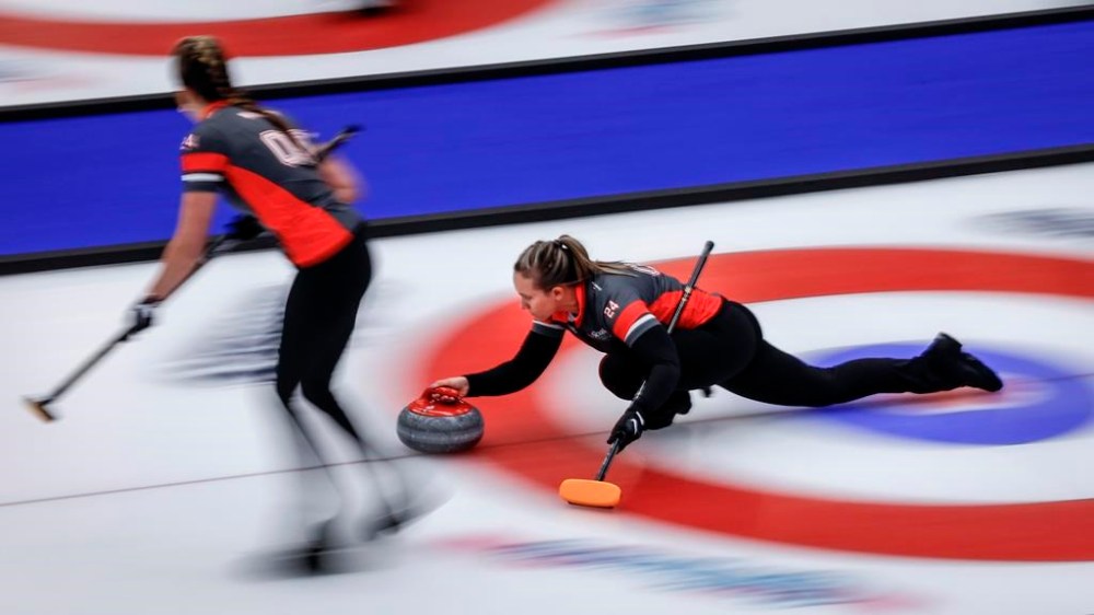 Team Ontario–Homan skip Rachel Homan, right, delivers a stone against Team British Columbia-Grandy at the Scotties Tournament of Hearts in Calgary, Wednesday, Feb. 21, 2024. THE CANADIAN PRESS/Jeff McIntosh