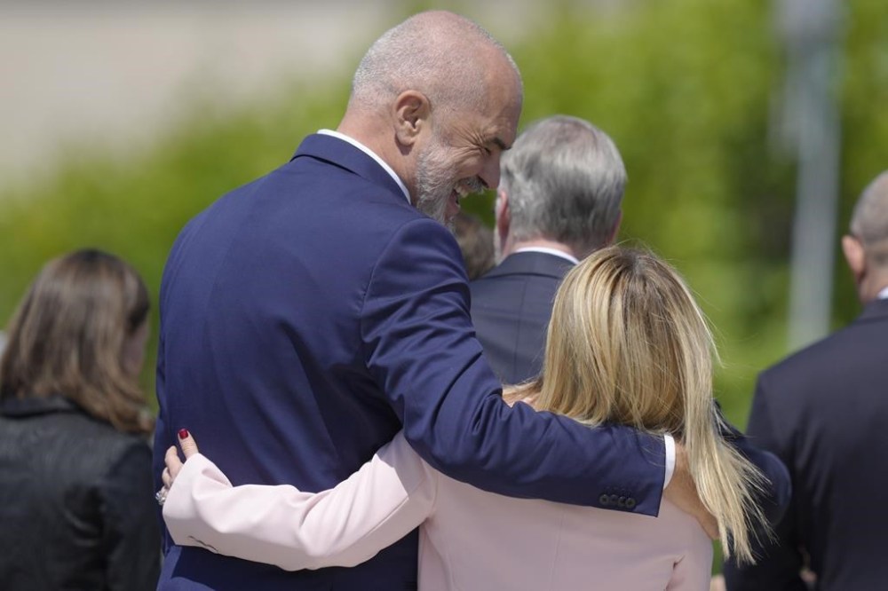 FILE - Albania's Prime Minister Edi Rama, left, walks with his arm around Italy's Prime Minister Giorgia Meloni after a group photo during the European Political Community Summit at the Mimi Castle in Bulboaca, Moldova, Thursday June 1, 2023. Albania's Assembly, or Parliament, votes on Thursday, Feb. 22, 2024, and is expected to approve a deal with Italy under which thousands of migrants rescued at sea by Italian authorities would be sent to Albania while their applications for asylum in Italy are processed. (AP Photo/Vadim Ghirda, File)