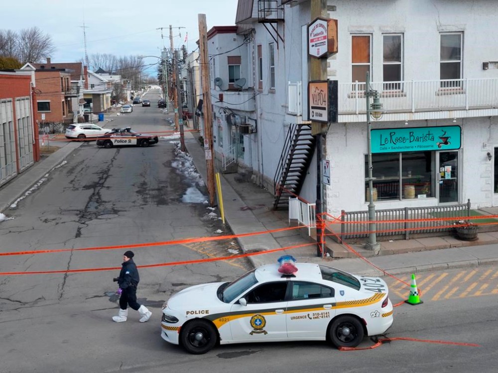 The father of a Quebec man who killed a provincial police officer last year says he had hoped his son would have been arrested and hospitalized before he could hurt someone. Police tape cordons off the scene after a Quebec provincial police officer was killed while trying to arrest a man in Louiseville, Que., Tuesday, March 28, 2023. THE CANADIAN PRESS/Ryan Remiorz