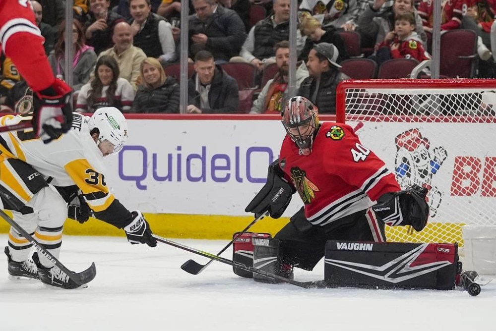 Chicago Blackhawks goaltender Arvid Soderblom makes a save against Pittsburgh Penguins centre Colin White during the first period of an NHL hockey game Thursday, Feb. 15, 2024, in Chicago. The Montreal Canadiens claimed White off waivers from the Penguins on Thursday. THE CANADIAN PRESS/AP-Erin Hooley
