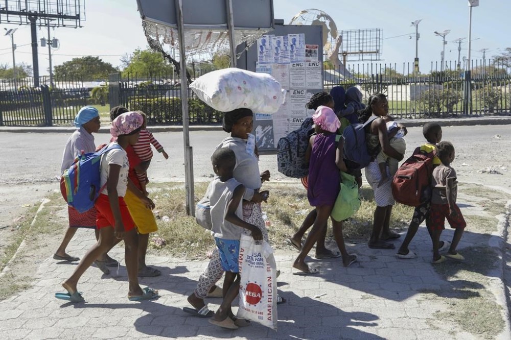 Global Affairs says Canada will give $80.5 million for a mission to improve security conditions in Haiti, where gang violence has caused an ongoing crisis. People flee their homes in Cite Soleil due to gang violence as they walk to a police station in Port-au-Prince, Haiti, Monday, Feb. 12, 2024. THE CANADIAN PRESS/AP-Odelyn Joseph