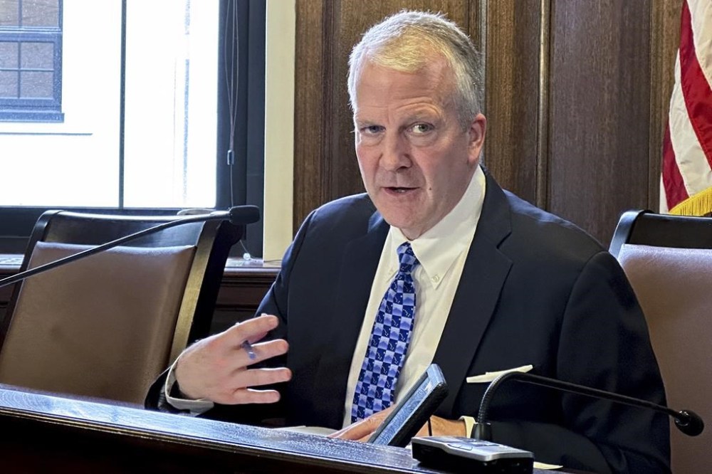 Sen. Dan Sullivan, R-Alaska, speaks to reporters after giving his annual speech to state lawmakers on Wednesday, Feb. 21, 2024, in Juneau, Alaska. Sullivan, among other things, expressed frustration with the Biden administration and actions that he said take aim at Alaska. (AP Photo/Becky Bohrer)