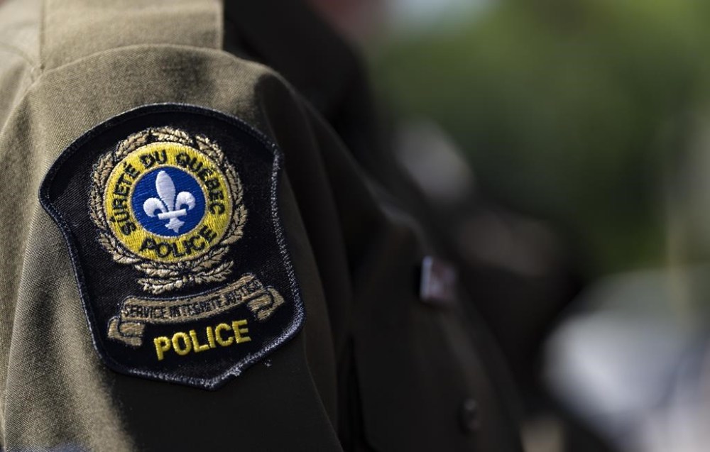 Quebec provincial police say they're cracking down after violent conflicts over drug turf between independent drug dealers and criminal biker gangs erupted in eastern Quebec. A provincial police emblem is seen on an officer’s uniform in Montreal, Tuesday, Aug. 22, 2023. THE CANADIAN PRESS/Christinne Muschi