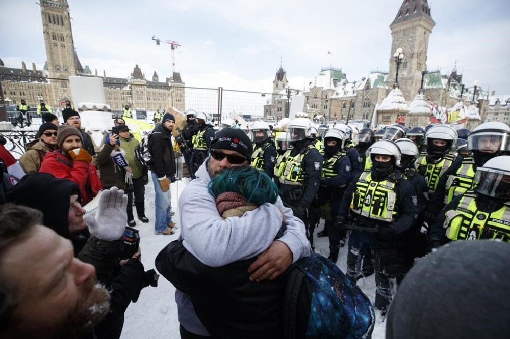 Police move in to clear downtown Ottawa near Parliament hill of protesters after weeks of demonstrations on Saturday, Feb. 19, 2022. The Liberal government is appealing a Federal Court decision that found its invocation of the Emergencies Act in 2022 was unjustified. THE CANADIAN PRESS/Cole Burston