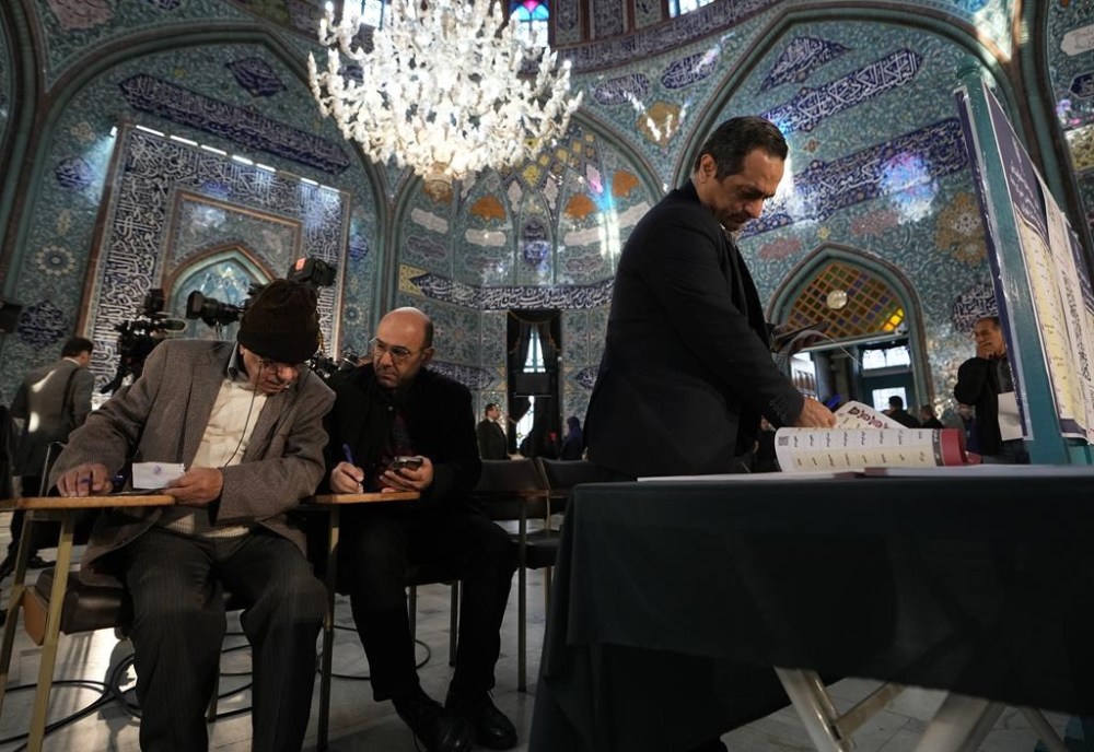 Voters fill out their ballots in the parliamentary and assembly of experts elections at a polling station in Tehran, Iran, Friday, March 1, 2024. Iran began voting Friday in its first elections since the mass 2022 protests over its mandatory hijab laws after the death of Mahsa Amini, with questions looming over just how many people will turn out for the poll. (AP Photo/Vahid Salemi)
