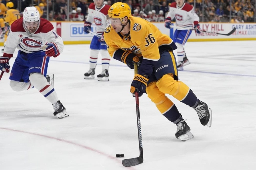 Nashville Predators left wing Cole Smith (36) skates the puck past Montreal Canadiens centre Alex Newhook, left, during the second period of an NHL hockey game Tuesday, March 5, 2024, in Nashville, Tenn. (AP Photo/George Walker IV)