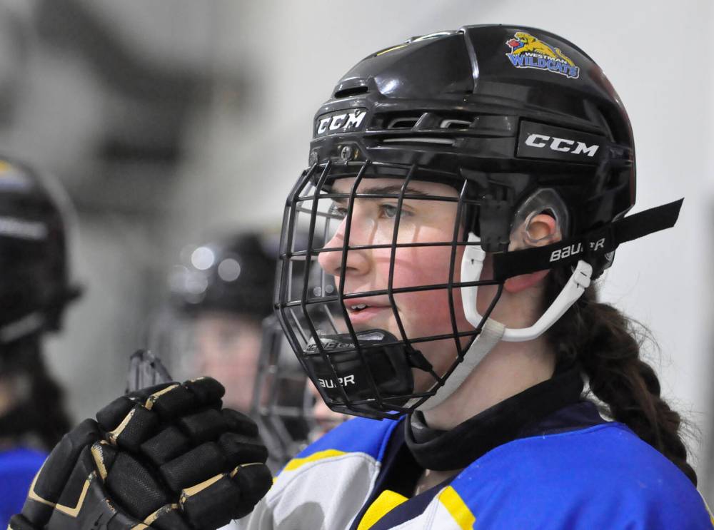 Westman Wildcats forward Reese Schutte awaits her turn from the bench at her team’s home arena in Hartney. (Jules Xavier/The Brandon Sun)