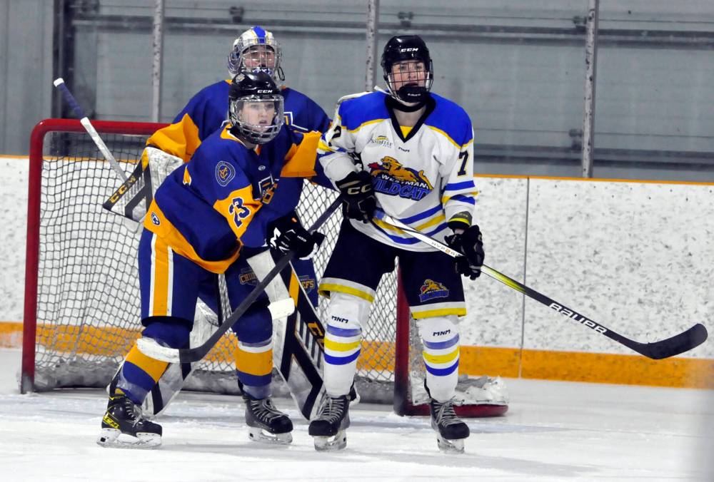 During a second-period power-play, Westman Wildcats sophomore forward Reese Schutte provides a screen in front of Yellowhead Chiefs goalie Clair Merckx, while being defended by Chiefs rearguard Grace Kirk (23). *(Jules Xavier/The Brandon Sun)