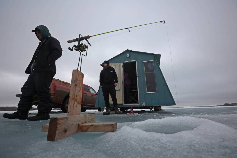 Owen Gercama and Tristan Stacy-Hopkie outside Brenda Hopkie's ice fishing shack on the Rivers Reservoir.