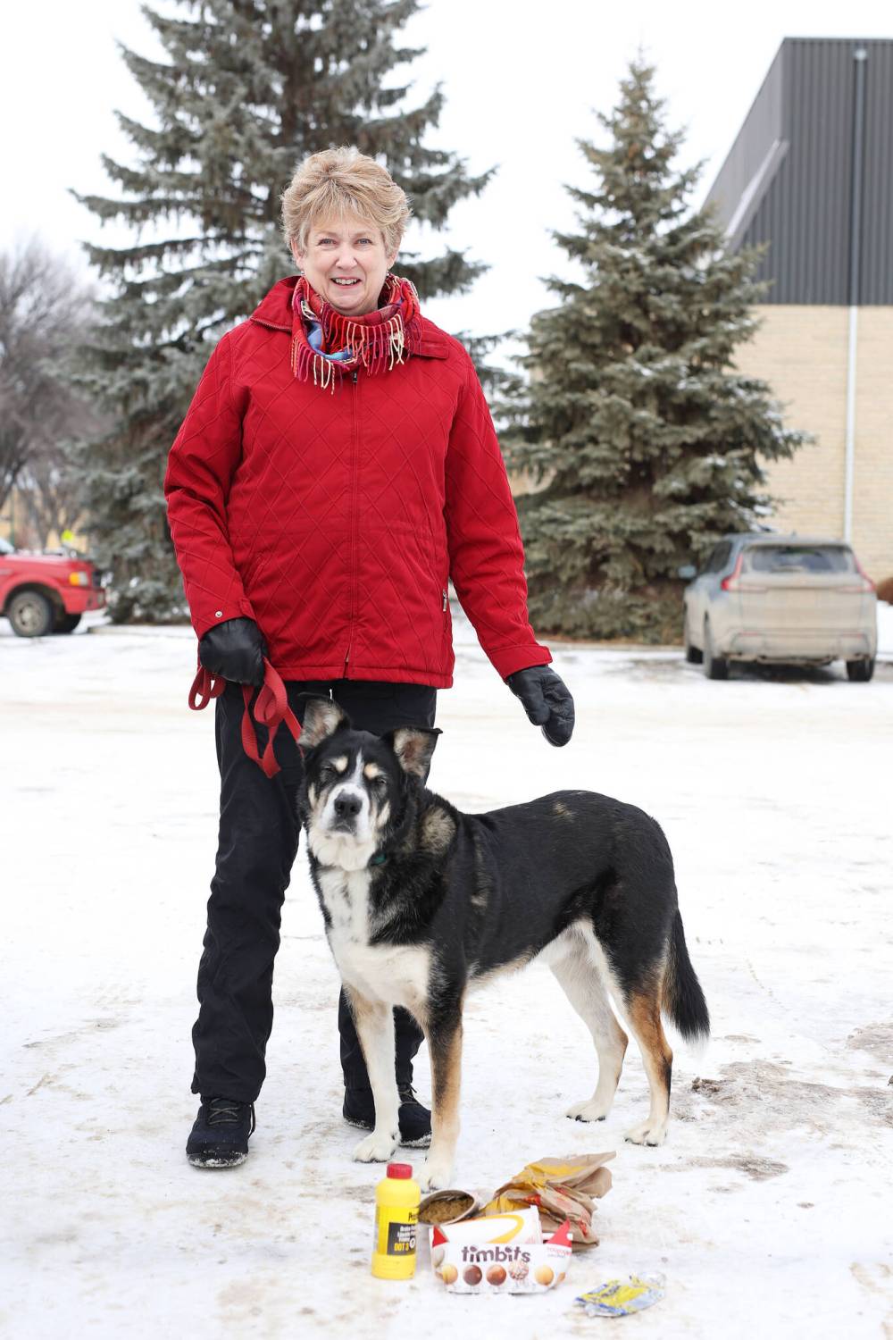 Jo-Anne Douglas and her dog Hayden with some of the litter they found during their walk along McDiarmid Drive on Monday. Douglas often picks up litter while on her daily walks with Hayden. (Tim Smith/The Brandon Sun)