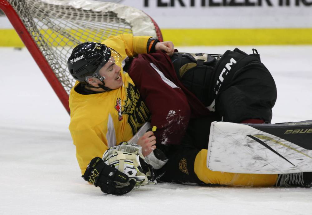 Matt Henry, shown laughing after being tackled by Wheat Kings netminder Ethan Eskit following a recent practice, said he fights to protect his his teammates. (Perry Bergson/The Brandon Sun)