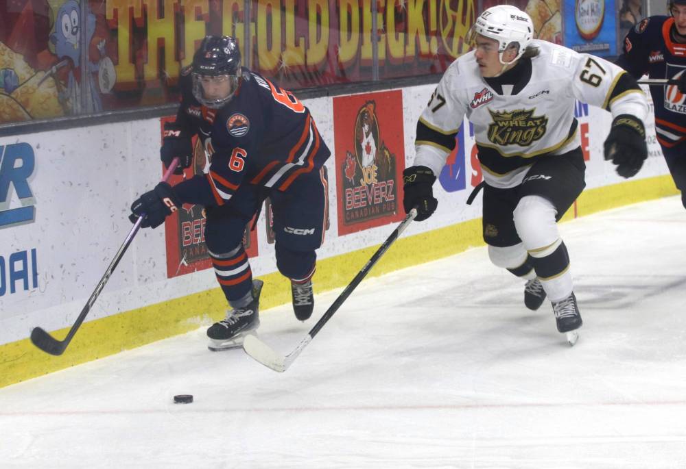 Brandon Wheat Kings forward Matt Henry lines up Kamloops Blazers defenceman Matteo Koci (6) for a hit during Western Hockey League action at Westoba Place on Dec. 9. Henry’s physicality is a key ingredient of his game. (Perry Bergson/The Brandon Sun)