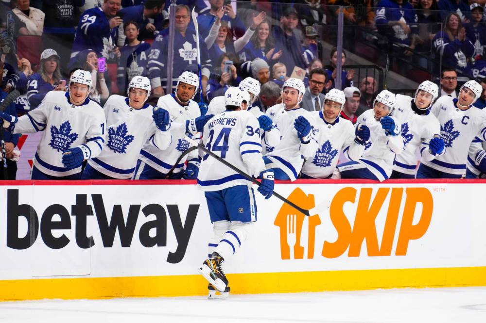 Toronto Maple Leafs centre Auston Matthews (34) celebrates a first period goal with the bench while taking on the Ottawa Senators in Ottawa on Feb. 10. Matthews is threatening to become the first NHLer in more than 30 years to hit the 70-goal mark. (The Canadian Press)