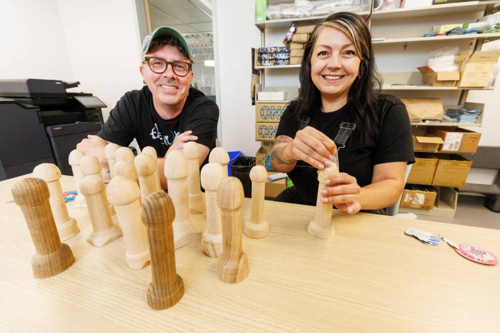 Gillian Roy (right), executive director of Sexual Education Resource Centre, with Jason Hooper show off wooden phalluses designed to demonstrate condom usage last year. On Friday, Roy told the Sun that it's always hard to tell whether a decrease in reported cases of infections like syphilis are due to fewer people being tested or the success of prevention efforts. (File)