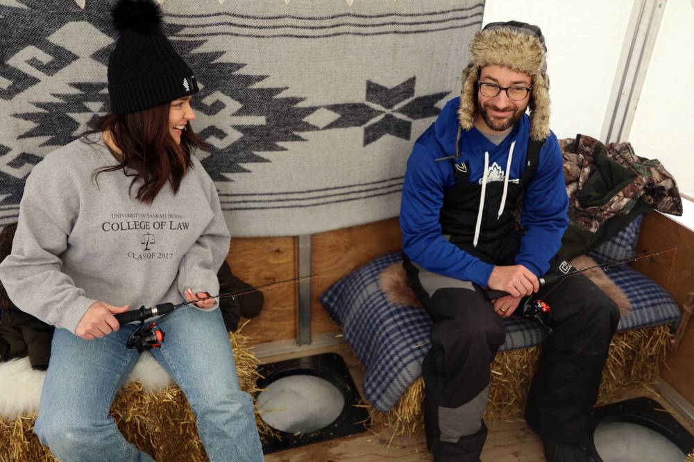 Stephan and Brooke Branigan enjoy some ice fishing inside a tent on Clear Lake on Saturday. (Colin Slark/The Brandon Sun)