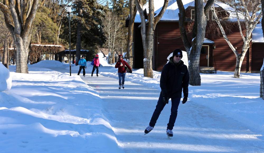 Visitors to Wasagaming in Riding Mountain National Park skate along frozen trails behind the visitor's centre on Saturday. (Colin Slark/The Brandon Sun)