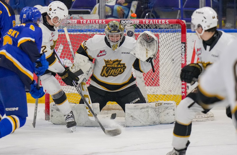 Brandon Wheat Kings goalie Carson Bjarnason (64) squares to save the puck as Saskatoon Blades forward Brandon Lisowsky (8) rushes to the net and defencemen Jackson DeSouza (2) and Andrei Maliavan (44) defend at SaskTel Centre on Sunday afternoon. The Blades won 3-1. (Steve Hiscock/Saskatoon Blades)