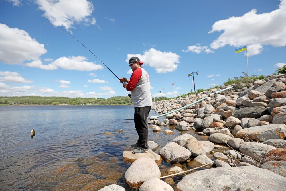 Cory McMurachy catches, then releases, a rock bass while fishing at Minnedosa Lake in 2020. (FILE/The Brandon Sun)