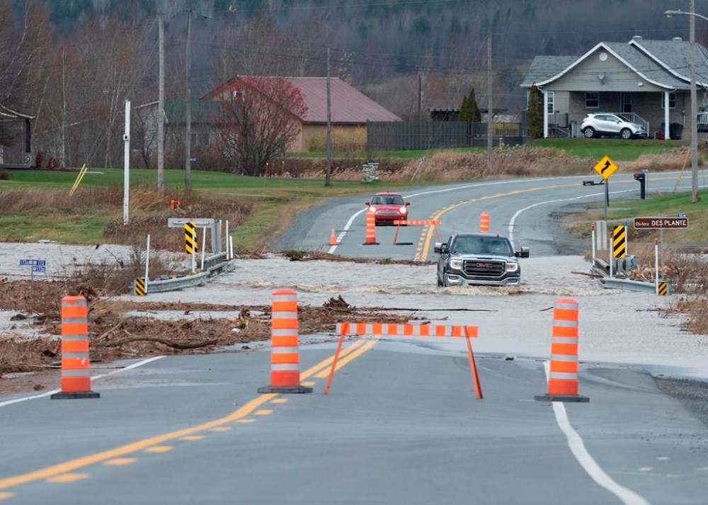 A truck driver makes his way through the flooded President-Kennedy road (R173), near Beauceville, Que. on Nov. 1, 2019.
