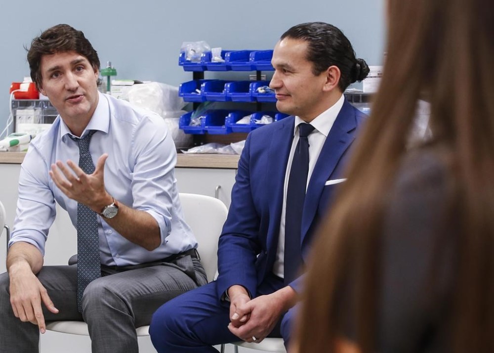 Manitoba Premier Wab Kinew is asking the federal government to call for an immediate ceasefire in the Israel-Hamas War. Prime Minister Justin Trudeau, centre, and Kinew, right, speak to students at Red River College Polytechnic in Winnipeg, Thursday, Feb. 15, 2024. THE CANADIAN PRESS/John Woods