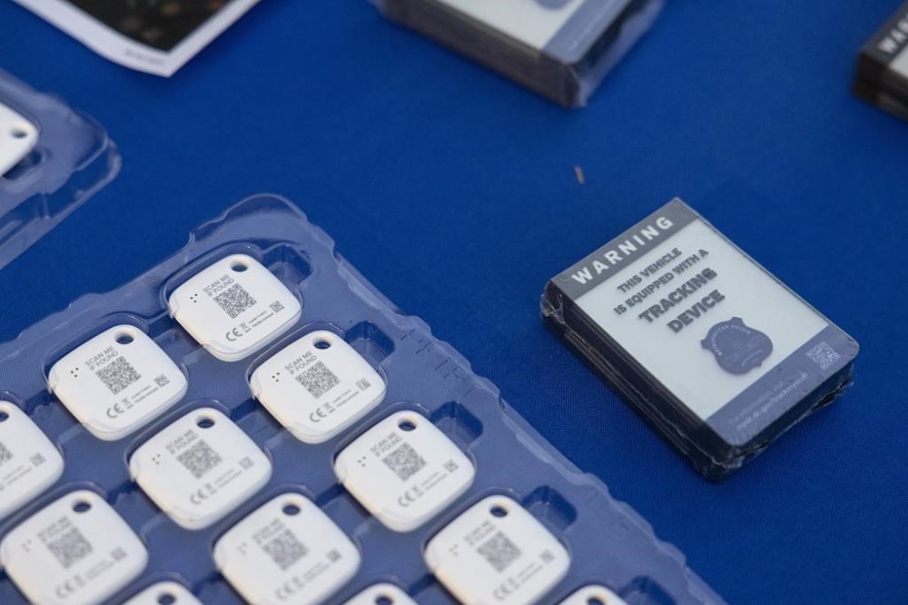 Mobile tracking devices and stickers from the Metropolitan Police Department are seen on a table in Washington on Tuesday, Nov. 7, 2023. Police in Burlington, Vt. say its residents are finding hidden AirTags and other GPS tracking devices on vehicles returning from Montreal. THE CANADIAN PRESS/AP-Amanda Andrade-Rhoades