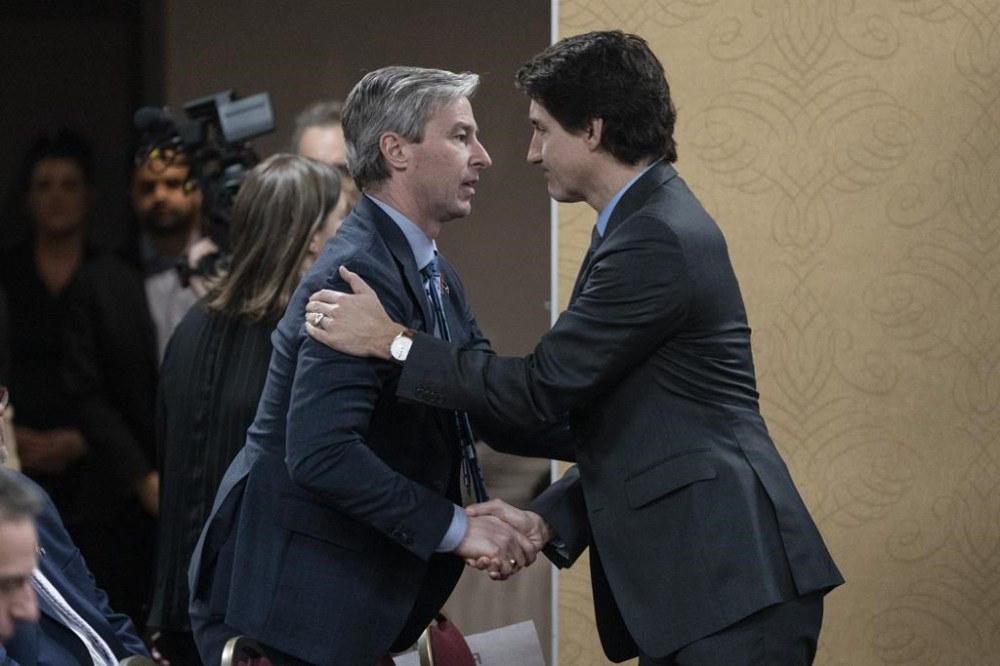 Prime Minister Justin Trudeau, right, is greeted by Nova Scotia Premier Tim Houston in Truro, N.S. on Thursday, March 30, 2023. Houston has joined a call from leaders across the country asking for a meeting with Trudeau about carbon pricing. THE CANADIAN PRESS/Darren Calabrese