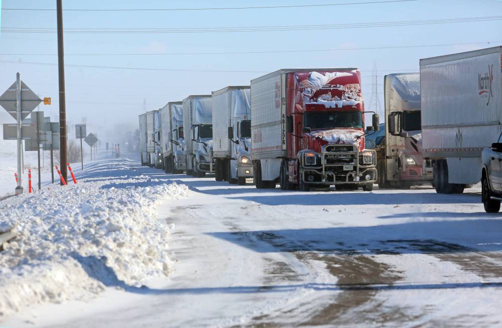 Westbound semi trucks were lined up along the Trans-Canada Highway at the First Street intersection on Monday morning as drivers waited for highways to reopen.(Matt Goerzen/The Brandon Sun)