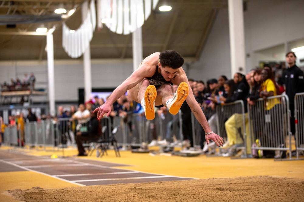 Daxx Turner soars toward the pit during the triple jump at the U Sports track and field championships in Winnipeg on Saturday. Turner jumped a personal-best 15.82 metres to win gold. (Photo courtesy Zachary Peters)