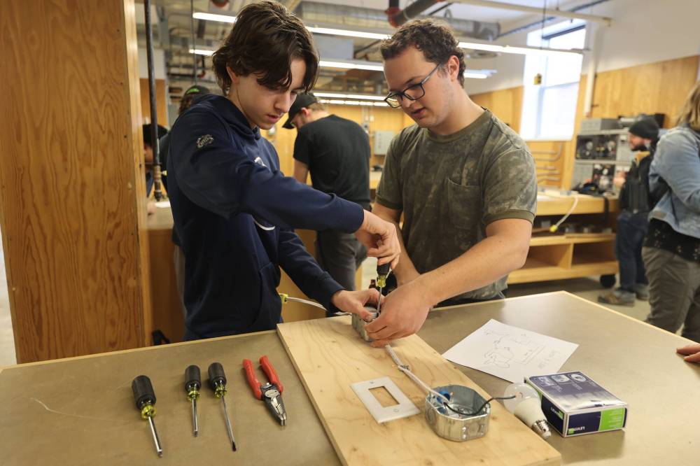Hamiota Collegiate student Keegan Rempel and Assiniboine Community College pre-employment student Levi Hiebert are focused on the task as Rempel gets firsthand experience with switch and light exercises in the construction electrician department during the Trades Summit on Thursday. (Photos by Abiola Odutola/The Brandon Sun)