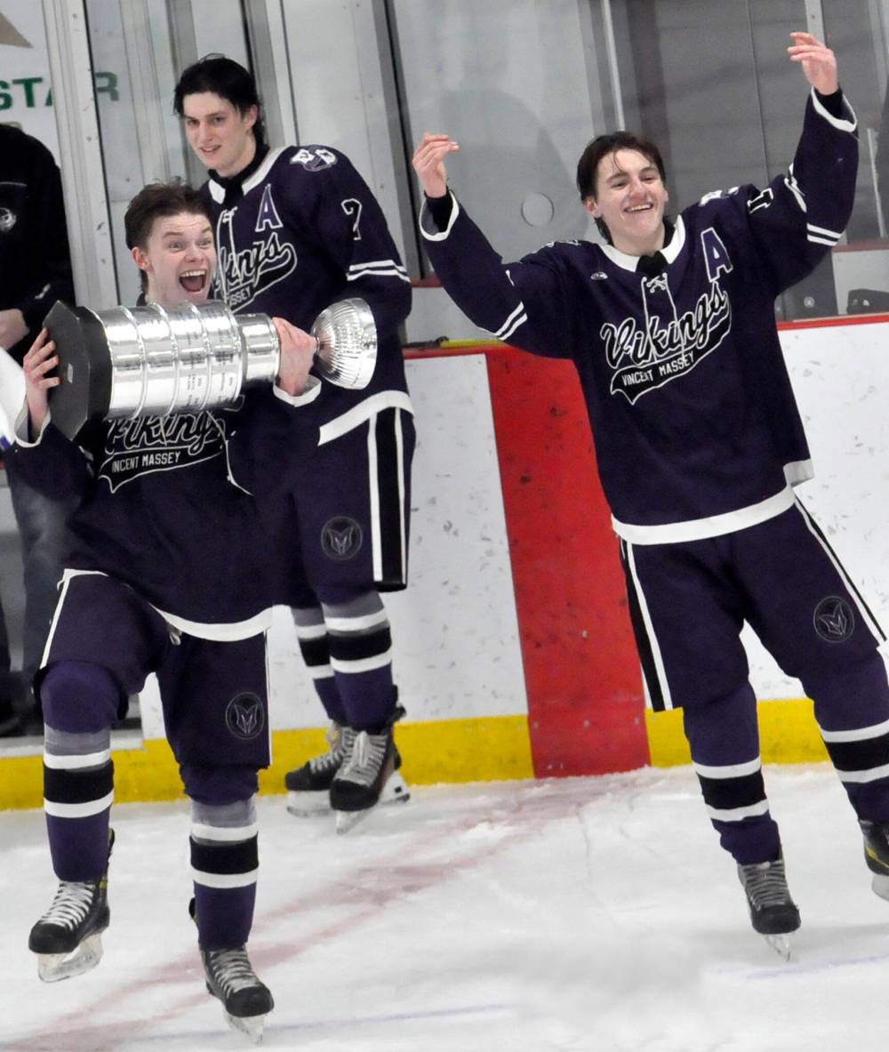 Vincent Massey Vikings captain Josh Ransom brings the WHSHL championship trophy to his awaiting teammates following their 3-2 victory Wednesday night over the Neepawa Tigers. (Jules Xavier/The Branton Sun)