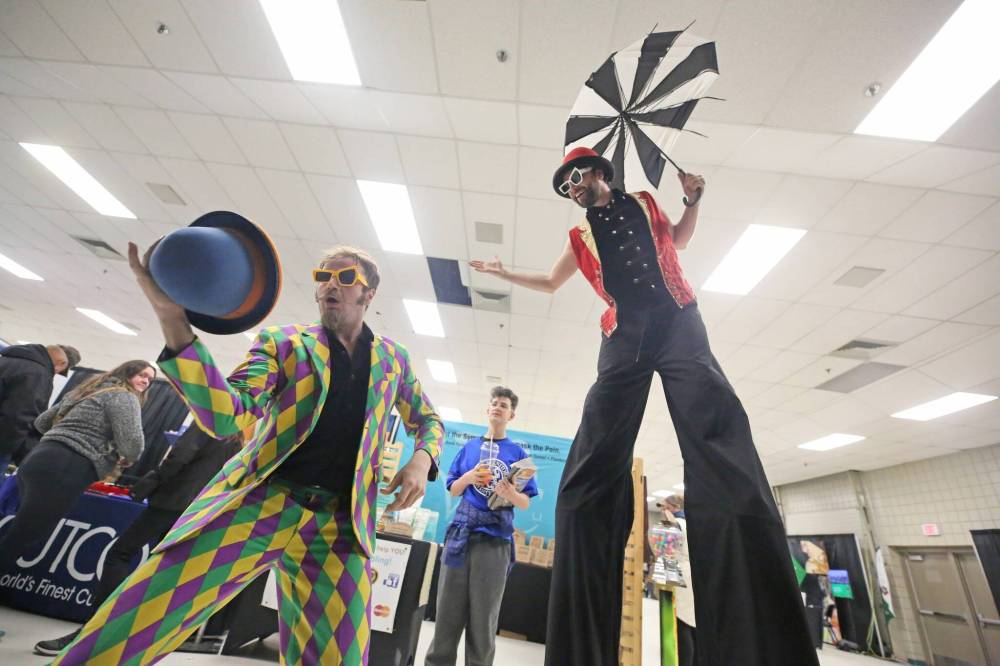 Noah Weigel (left) and Joey Vedres (right) of the Three Hat Circus ham it up between shows as they walk through the trade show in the Keystone Centre at the Royal Manitoba Winter Fair. (Matt Goerzen/The Brandon Sun)