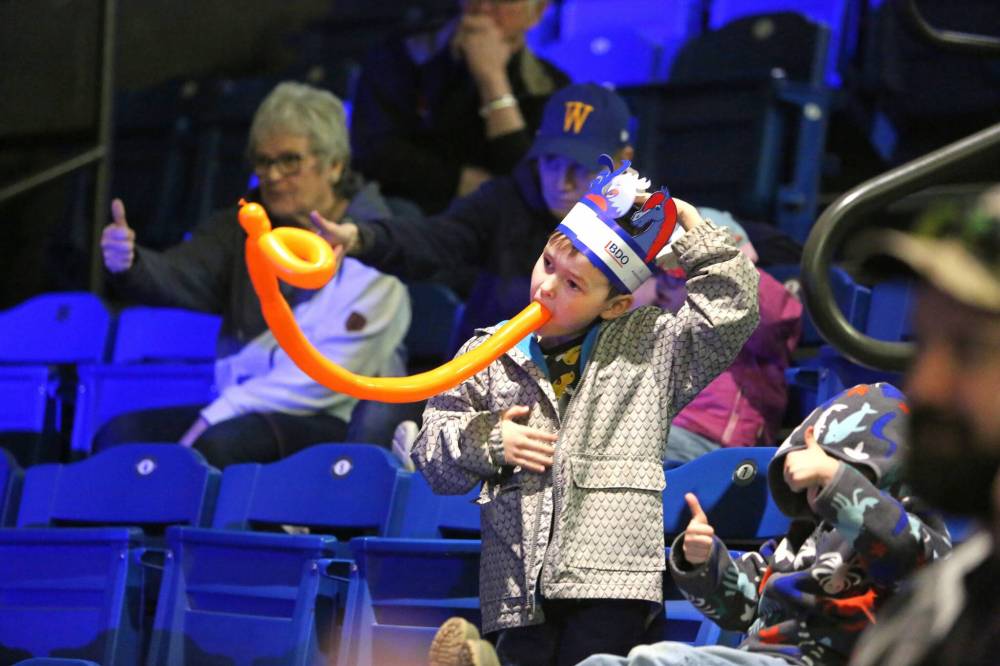 Six-year-old Lucas Clark pats his head and rubs his tummy during the Amanda Panda Hula Hoop Circus show on Monday afternoon, while holding a balloon animal in his mouth. (Matt Goerzen/The Brandon Sun)