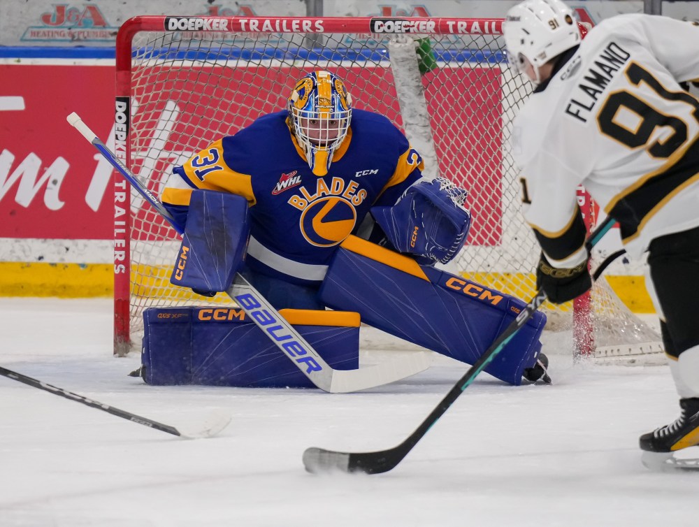 Saskatoon Blades goaltender Austin Elliott (31) prepares to turn aside a shot by Brandon Wheat Kings forward Nolan Flamand (91) at SaskTel Centre on Tuesday. Elliott earned his third shutout of the season against Brandon in a 4-0 decision. (Steve Hiscock/Saskatoon Blades)