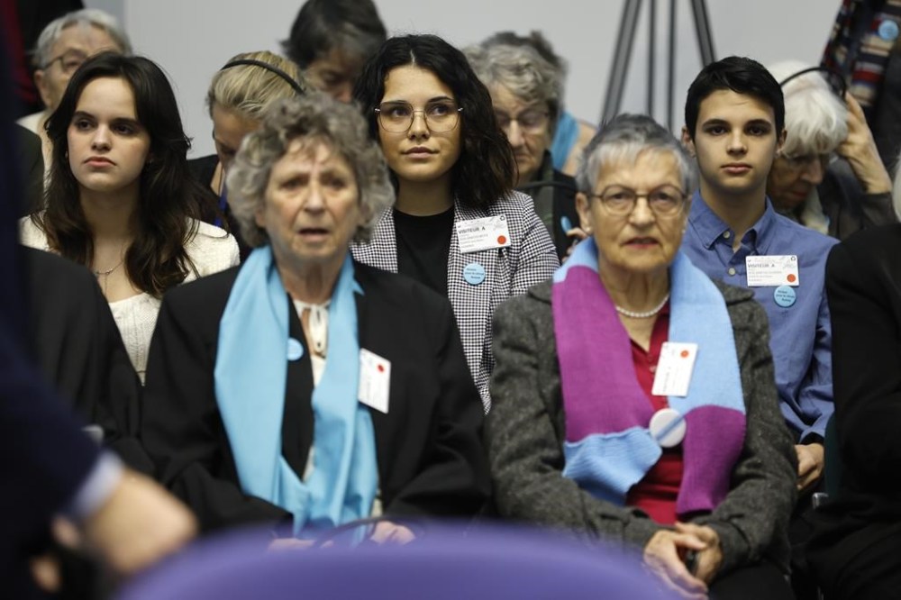 Portugal's Catarina dos Santos Mota, center, attends the session at the European Court of Human Rights Tuesday, April 9, 2024 in Strasbourg, eastern France. Europe's highest human rights court will rule Tuesday on a group of landmark climate change cases aimed at forcing countries to meet international obligations to reduce greenhouse gas emissions. The European Court of Human Rights will hand down decisions in a trio of cases brought by a French mayor, six Portuguese youngsters and more than 2,000 elderly Swiss women who say their governments are not doing enough to combat climate change. (AP Photo/Jean-Francois Badias)