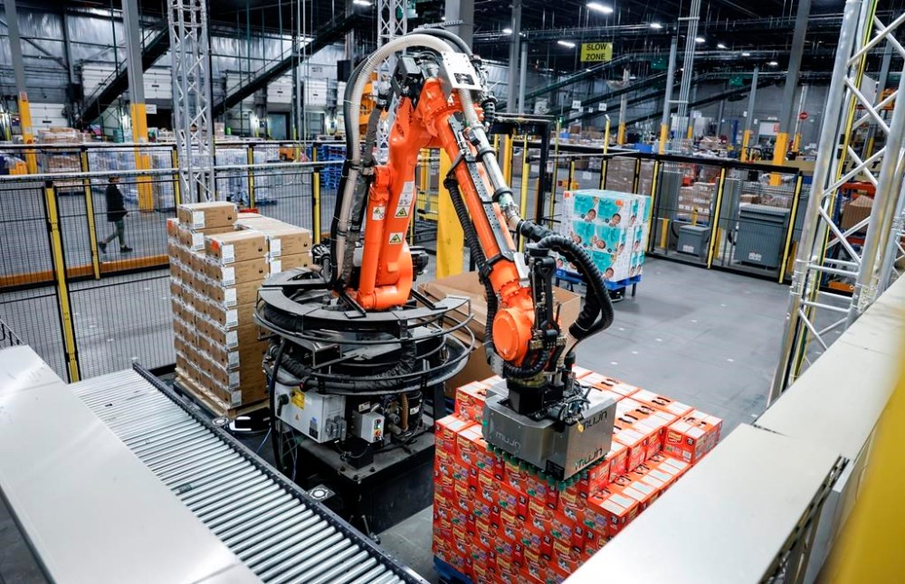 A robot unloads a pallet of cat food at a Walmart distribution centre in Calgary, Thursday, March 28, 2024. Walmart Canada is planning to bring robots to two Ontario distribution centres. THE CANADIAN PRESS/Jeff McIntosh